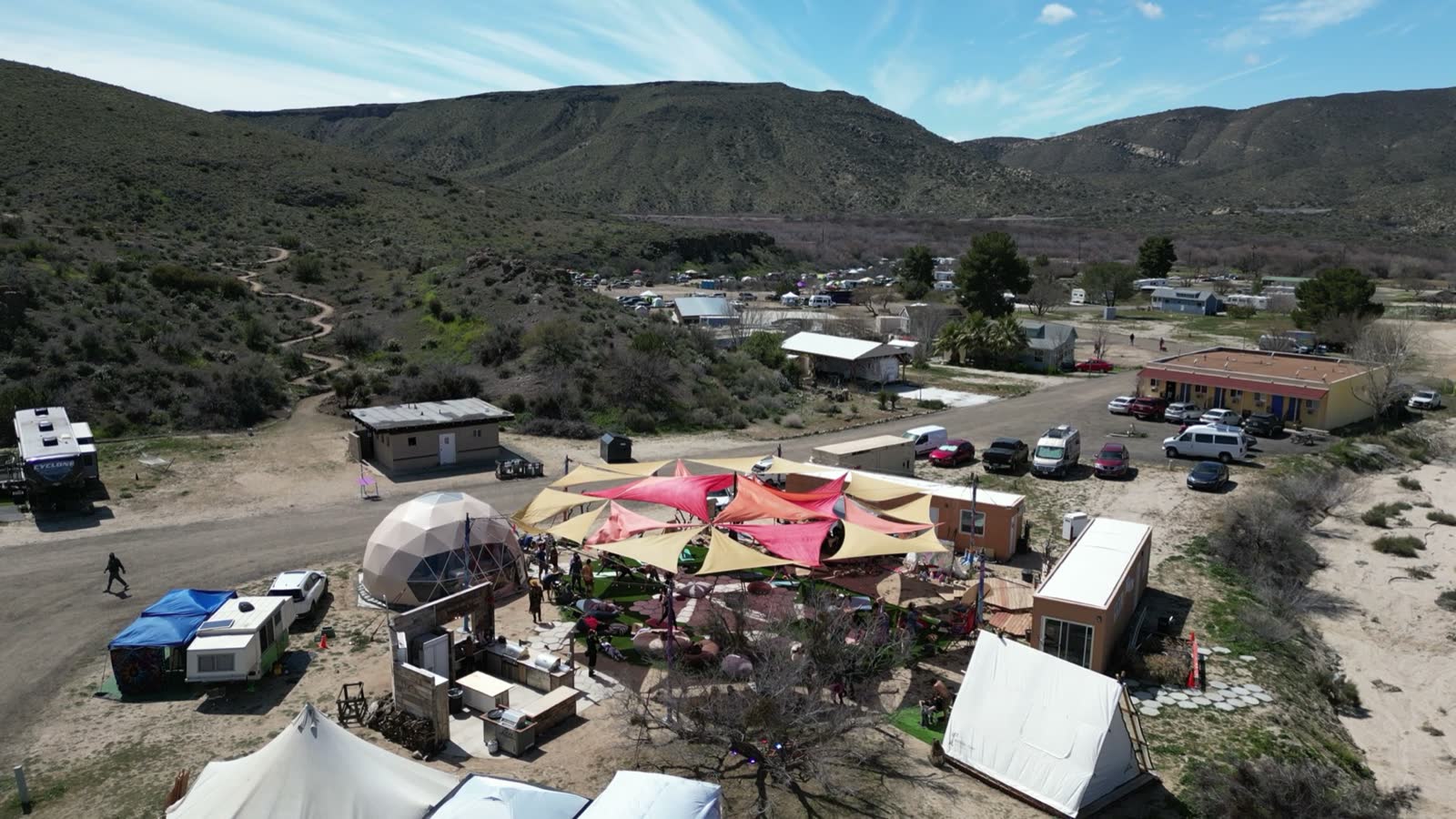 Real aerial of the existing dome and shade-sail gathering zone
